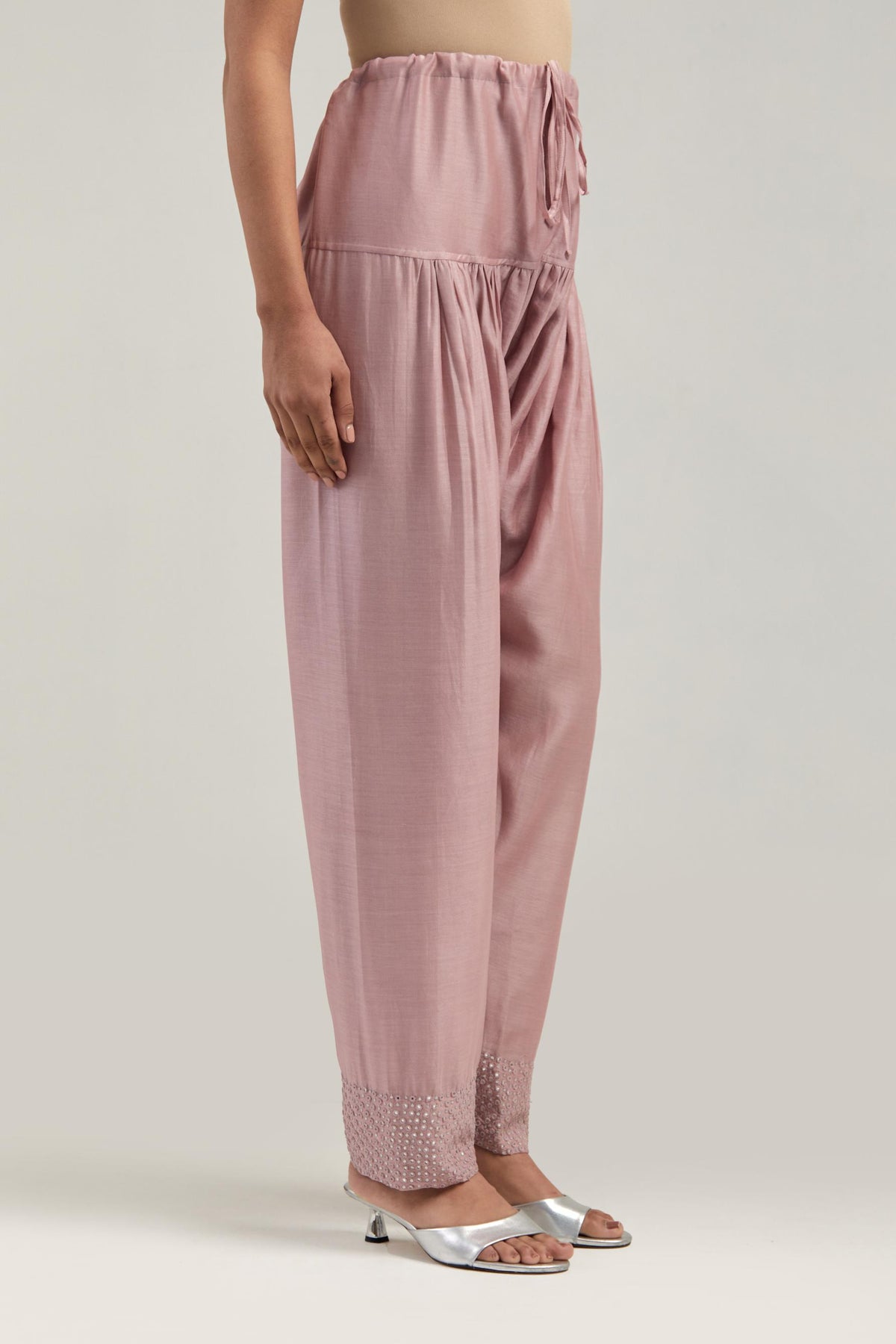 Pink silk Chanderi salwar with hand-embroidered mirror & sequins work in a broad border at the hem.