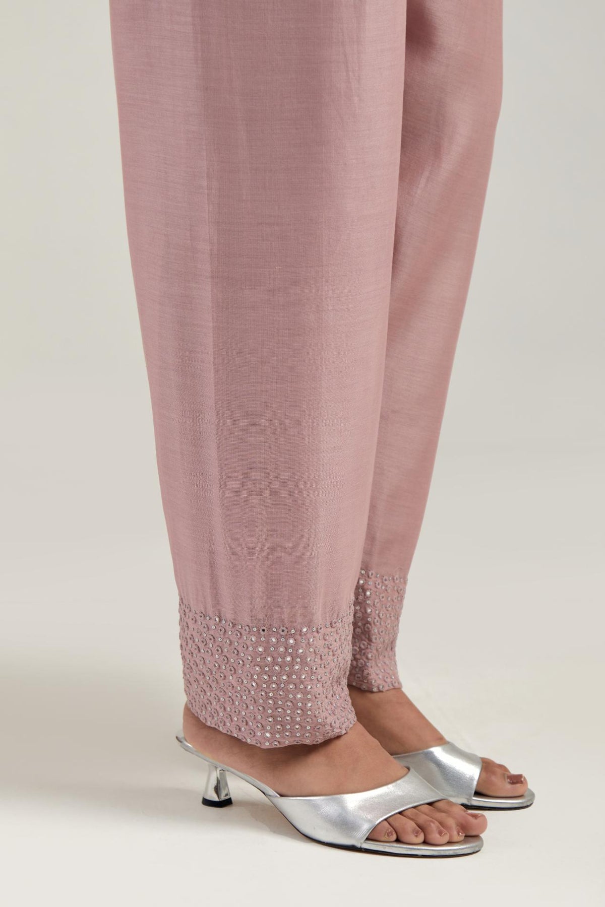 Pink silk Chanderi salwar with hand-embroidered mirror & sequins work in a broad border at the hem.