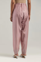 Pink silk Chanderi salwar with hand-embroidered mirror & sequins work in a broad border at the hem.