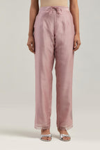 Pink silk Chanderi straight pants with narrow organza scalloped hem and hand-embroidered diamond motifs with delicate mirror & sequins work at the sides.
