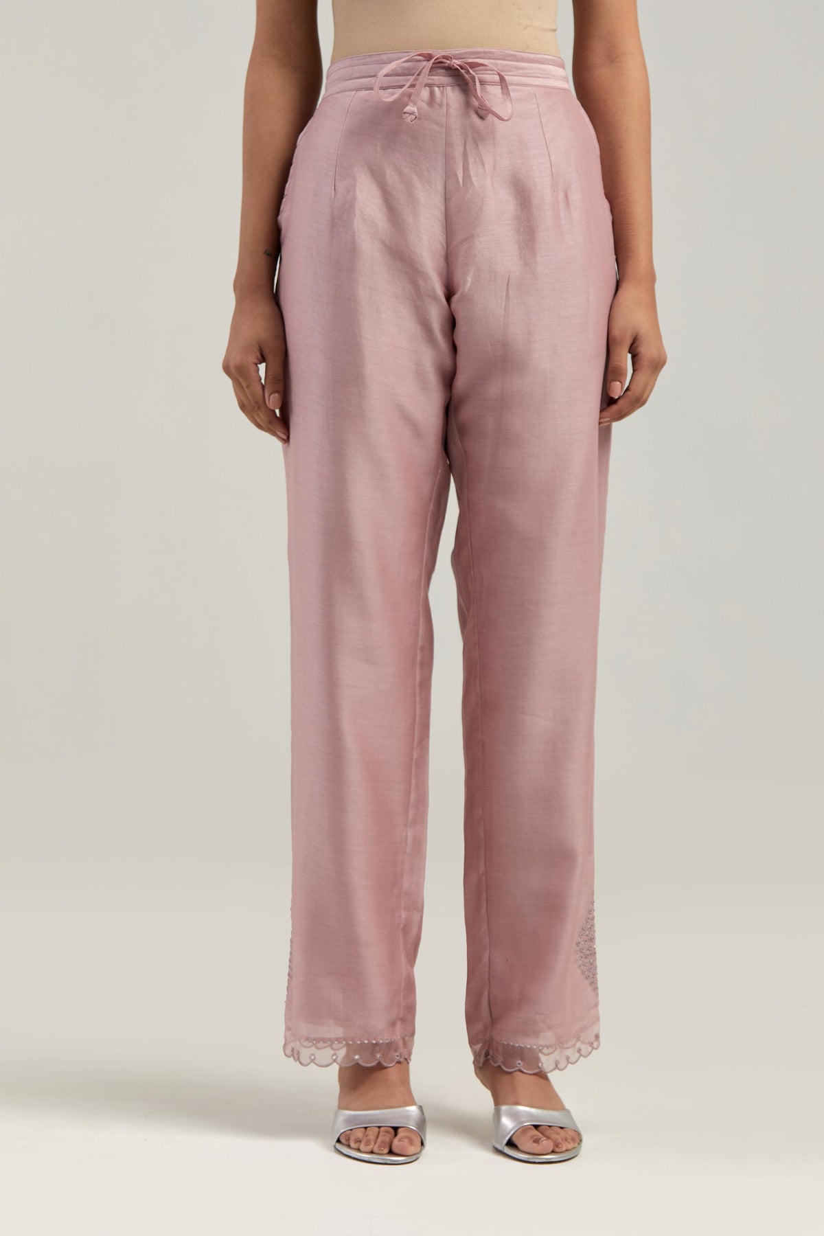 Pink silk Chanderi straight pants with narrow organza scalloped hem and hand-embroidered diamond motifs with delicate mirror & sequins work at the sides.