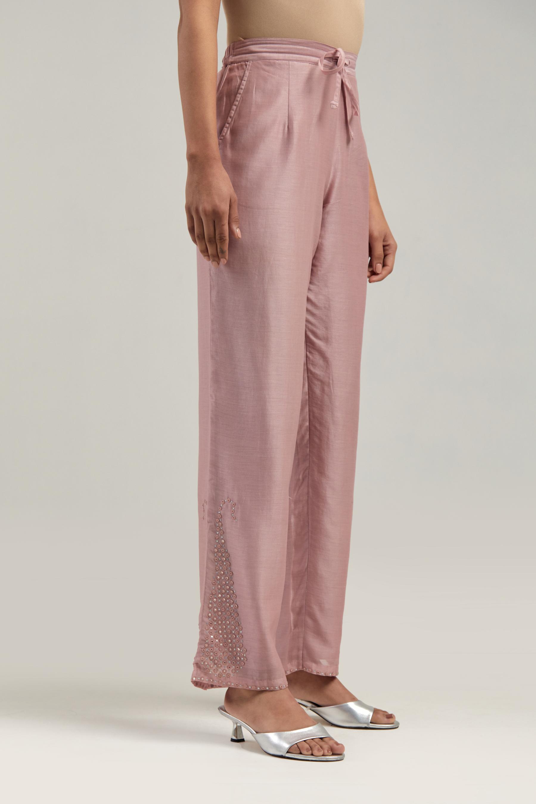Pink silk Chanderi pants with hand-embroidered paisley motifs with delicate mirror and sequins work at the hem.