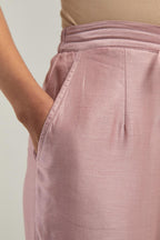 Pink silk Chanderi pants with hand-embroidered paisley motifs with delicate mirror and sequins work at the hem.