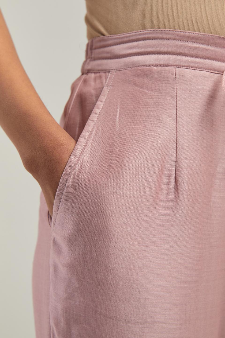 Pink silk Chanderi pants with hand-embroidered paisley motifs with delicate mirror and sequins work at the hem.