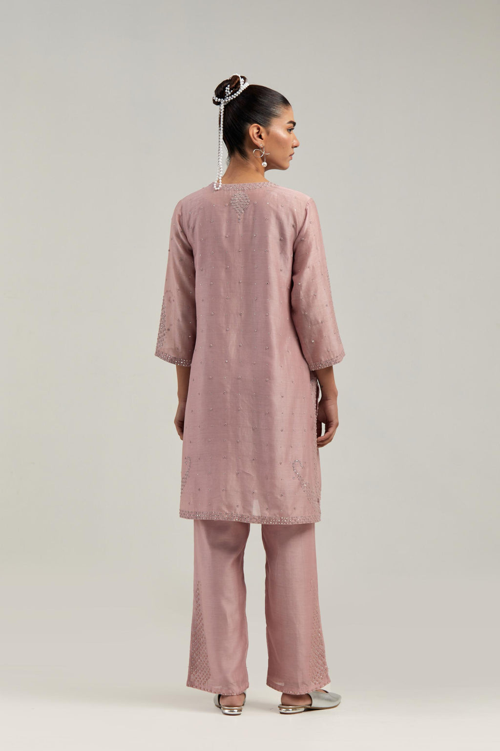 Pink silk Chanderi straight short kurta set with hand-embroidered paisley motifs with delicate mirror and sequins work at neck, hem, and sleeves, with narrow borders along the edges.