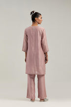 Pink silk Chanderi straight short kurta set with hand-embroidered paisley motifs with delicate mirror and sequins work at neck, hem, and sleeves, with narrow borders along the edges.