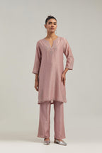 Pink silk Chanderi straight short kurta set with hand-embroidered paisley motifs with delicate mirror and sequins work at neck, hem, and sleeves, with narrow borders along the edges.