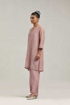 Pink silk Chanderi straight short kurta set with hand-embroidered paisley motifs with delicate mirror and sequins work at neck, hem, and sleeves, with narrow borders along the edges.