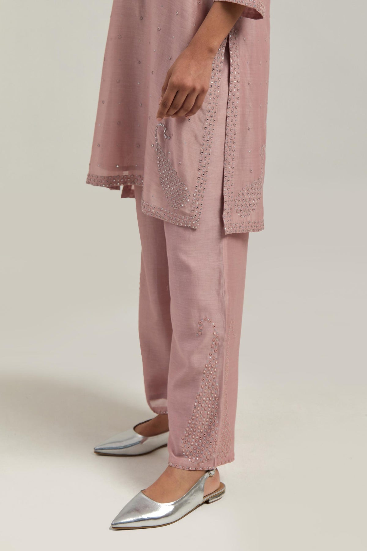 Pink silk Chanderi straight short kurta set with hand-embroidered paisley motifs with delicate mirror and sequins work at neck, hem, and sleeves, with narrow borders along the edges.