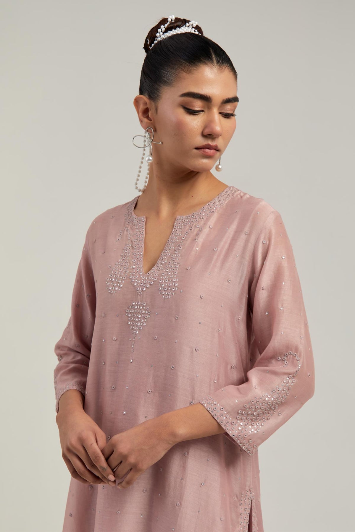 Pink silk Chanderi straight short kurta set with hand-embroidered paisley motifs with delicate mirror and sequins work at neck, hem, and sleeves, with narrow borders along the edges.