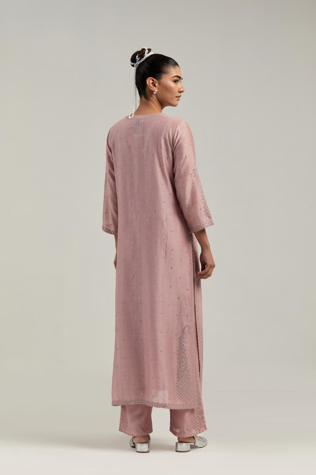 Pink silk Chanderi straight kurta set with hand-embroidered paisley motifs with delicate mirror and sequins work at neck, hem, and sleeves, with narrow borders along the edges.