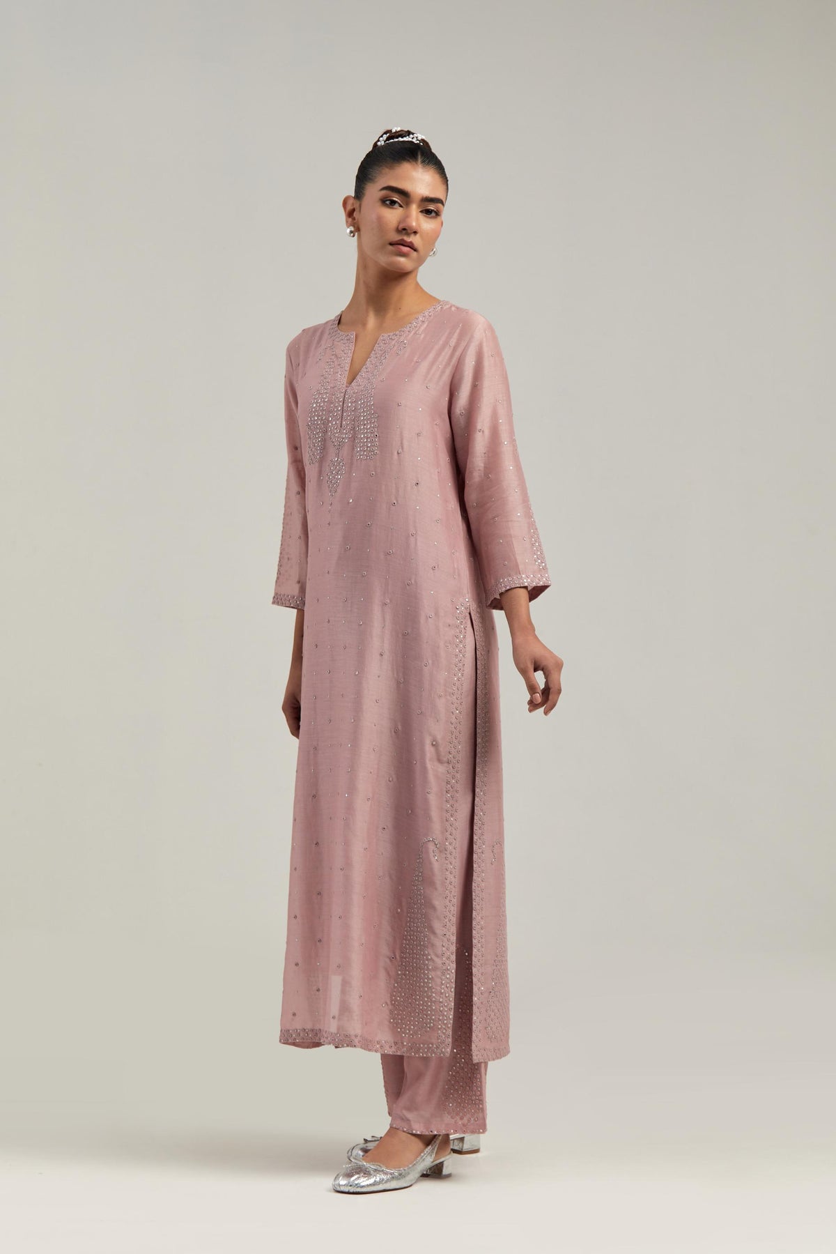Pink silk Chanderi straight kurta set with hand-embroidered paisley motifs with delicate mirror and sequins work at neck, hem, and sleeves, with narrow borders along the edges.