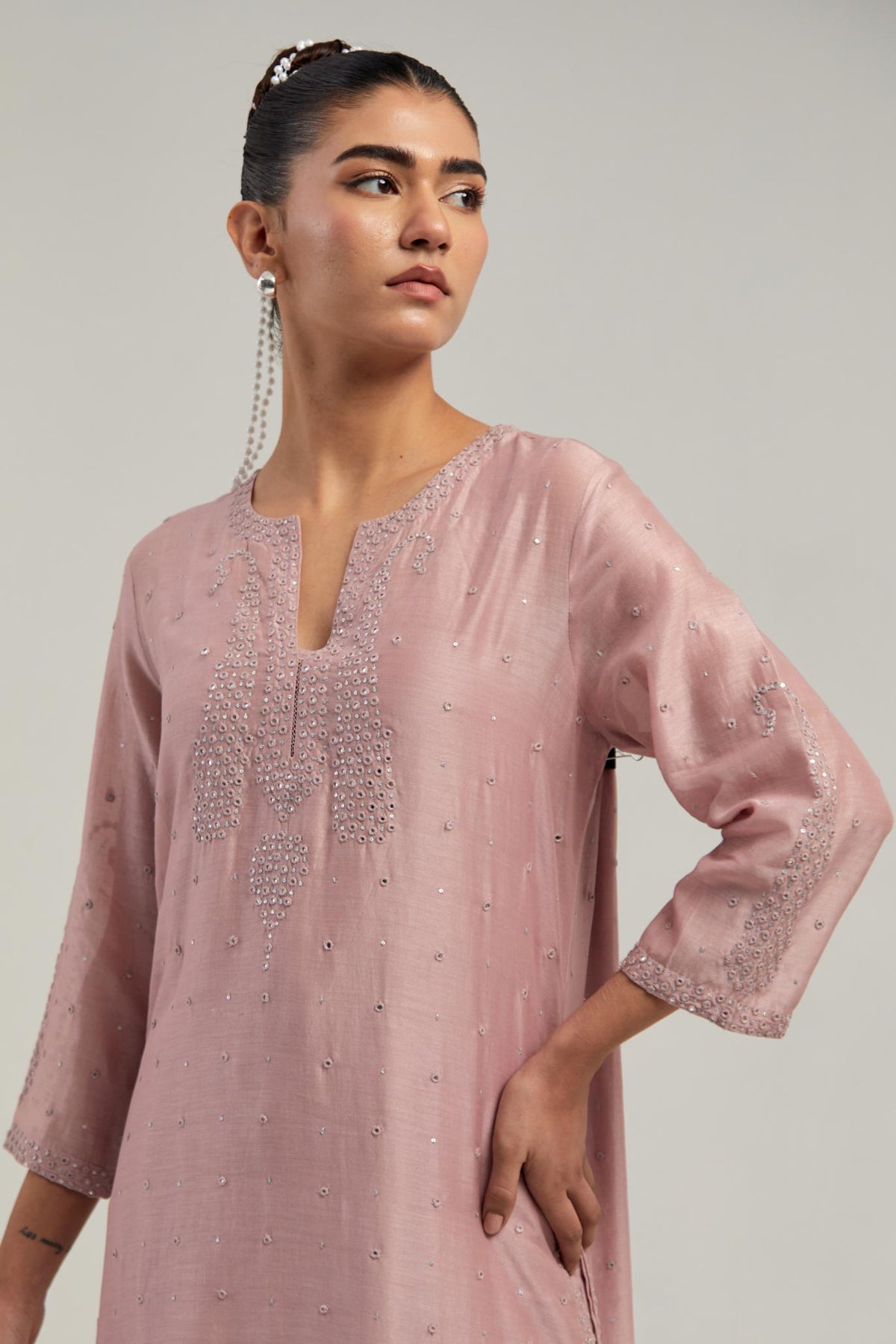 Pink silk Chanderi straight kurta set with hand-embroidered paisley motifs with delicate mirror and sequins work at neck, hem, and sleeves, with narrow borders along the edges.
