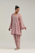 Pink silk Chanderi short A-line kurta set with hand-embroidered mirror work at the neck and bell sleeves.