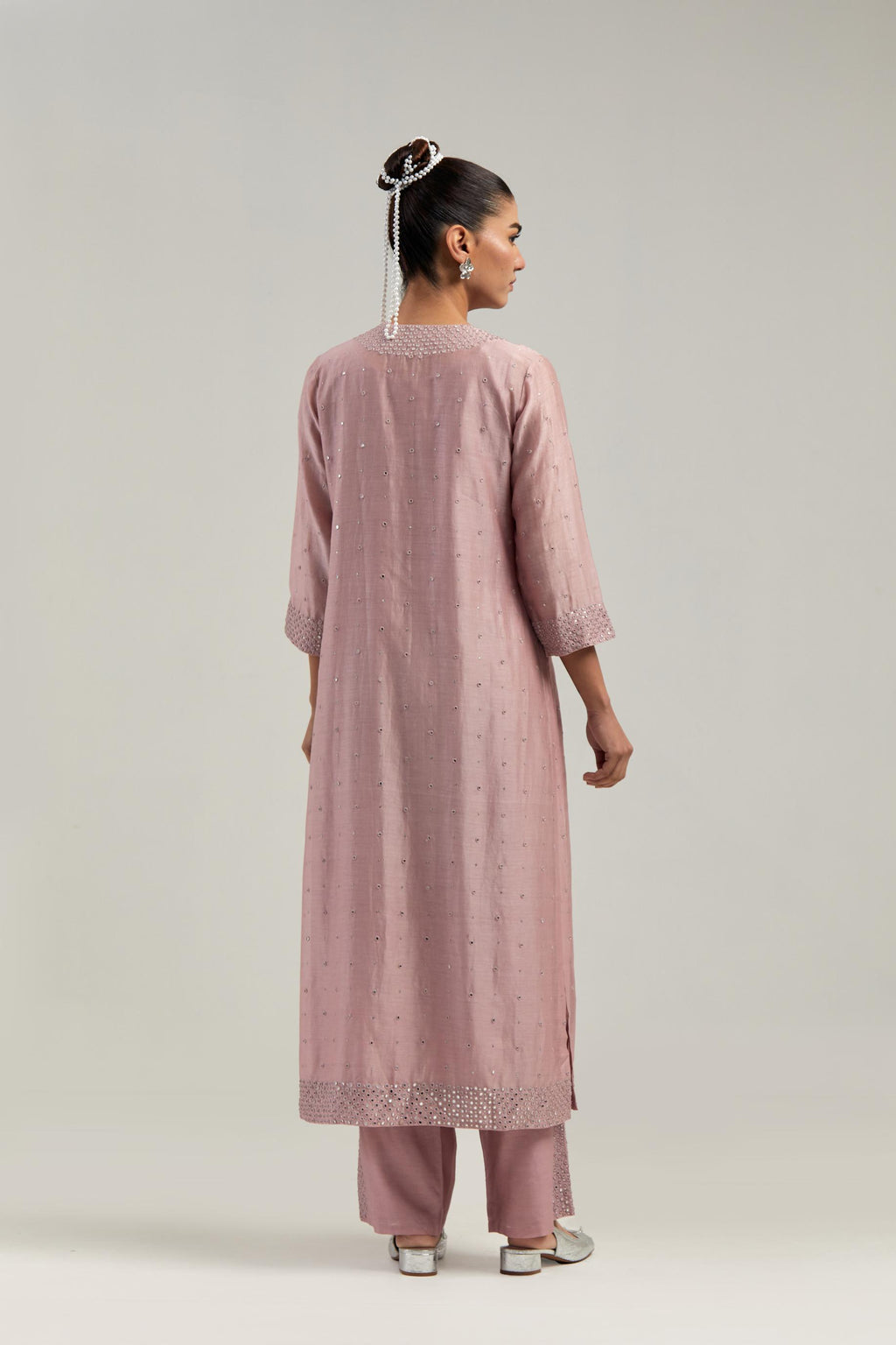 Pink silk Chanderi straight kurta set with hand-embroidered mirror at the neck, hem and sleeves, highlighted with scattered silver sequin and mirror embellishments all-over.