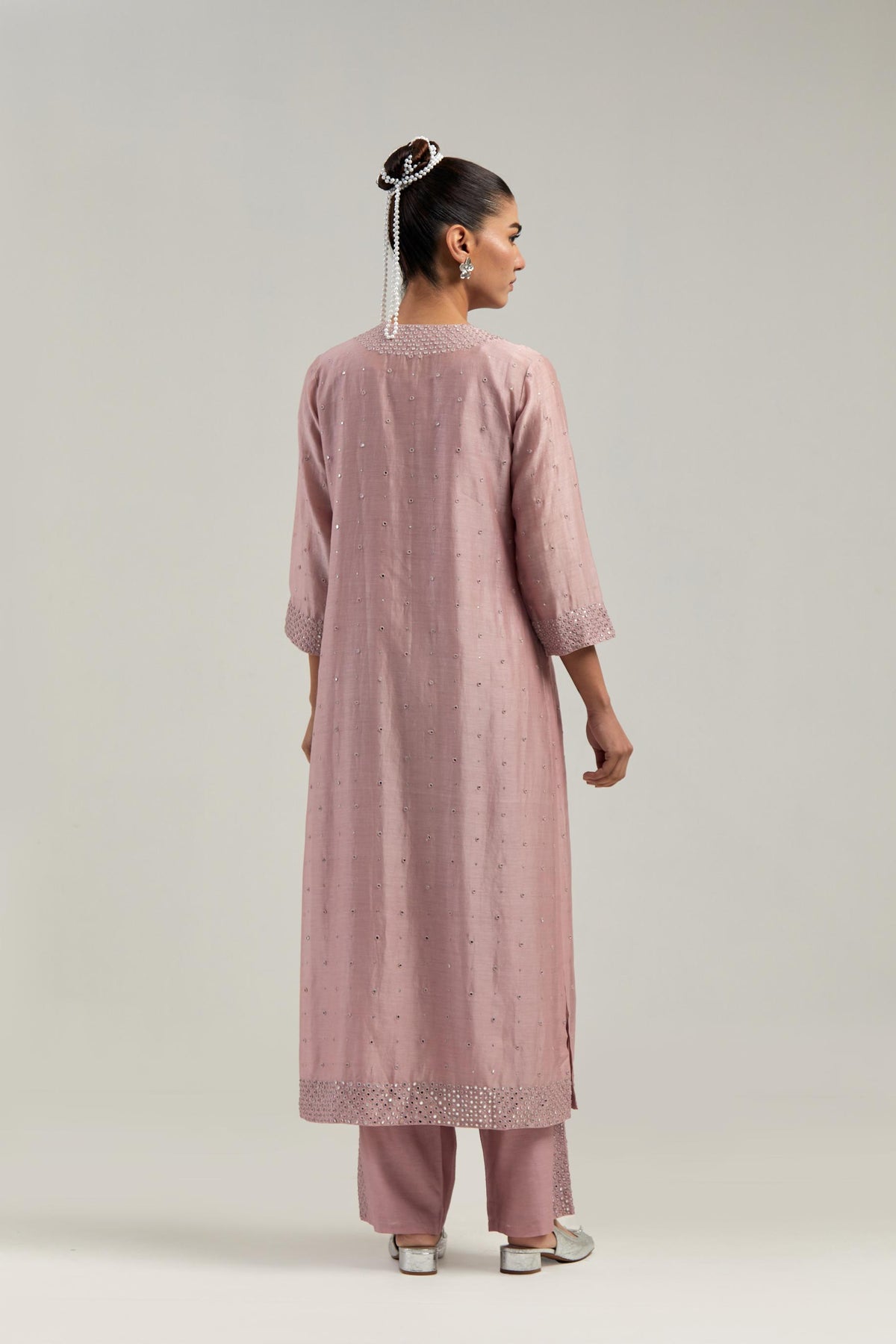 Pink silk Chanderi straight kurta set with hand-embroidered mirror at the neck, hem and sleeves, highlighted with scattered silver sequin and mirror embellishments all-over.