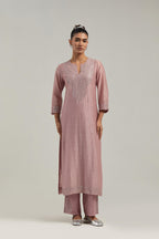 Pink silk Chanderi straight kurta set with hand-embroidered mirror at the neck, hem and sleeves, highlighted with scattered silver sequin and mirror embellishments all-over.