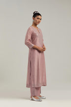 Pink silk Chanderi straight kurta set with hand-embroidered mirror at the neck, hem and sleeves, highlighted with scattered silver sequin and mirror embellishments all-over.