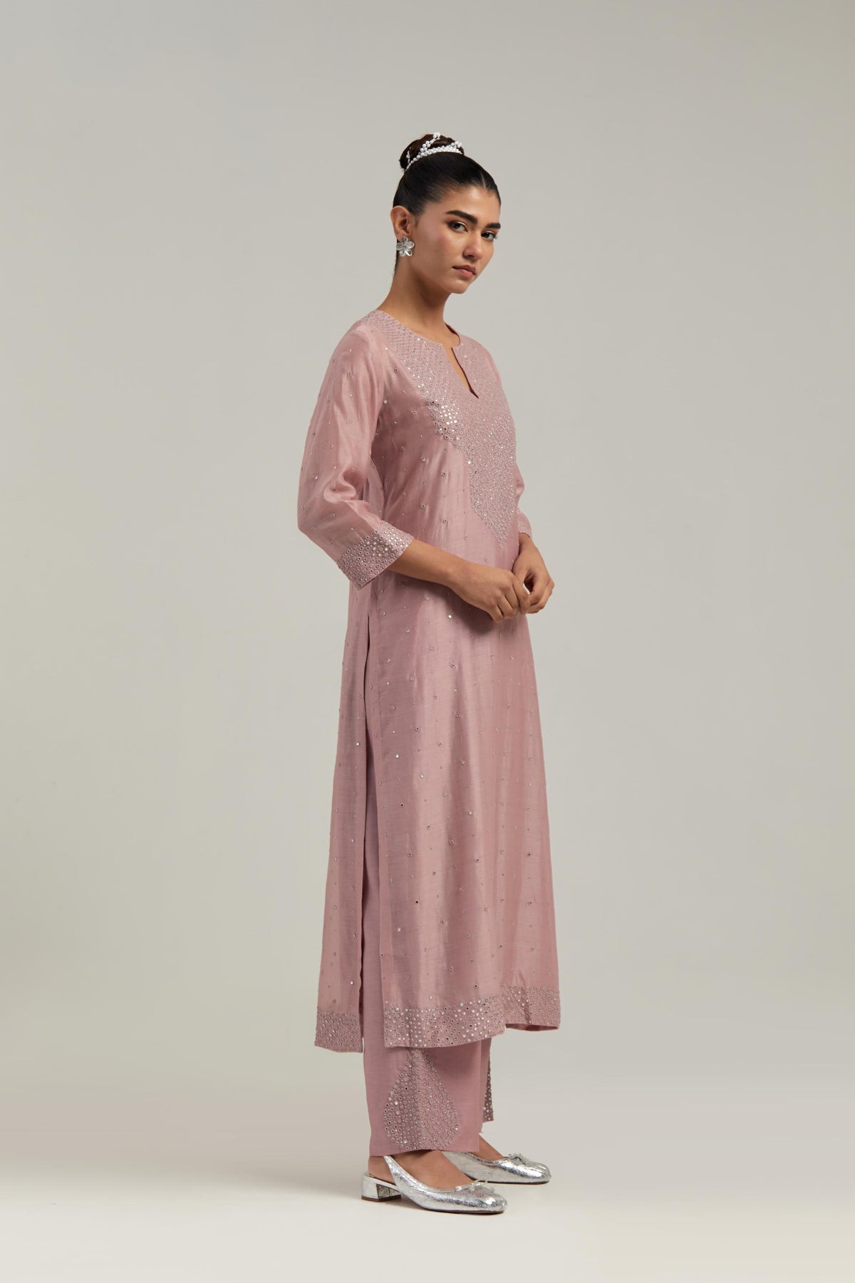 Pink silk Chanderi straight kurta set with hand-embroidered mirror at the neck, hem and sleeves, highlighted with scattered silver sequin and mirror embellishments all-over.