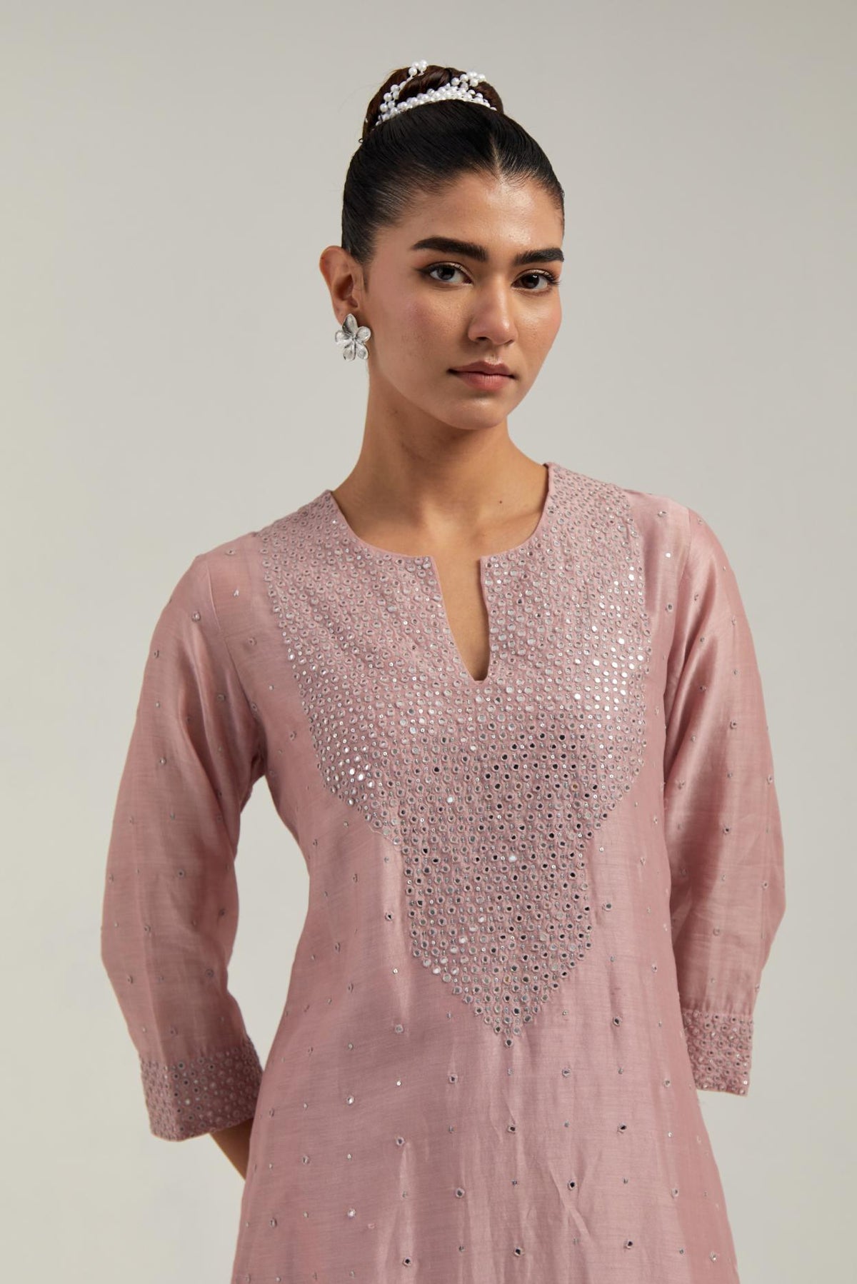 Pink silk Chanderi straight kurta set with hand-embroidered mirror at the neck, hem and sleeves, highlighted with scattered silver sequin and mirror embellishments all-over.