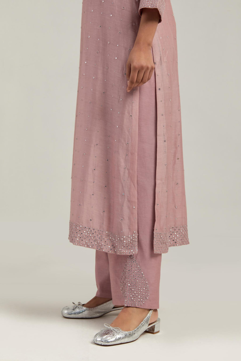 Pink silk Chanderi straight kurta set with hand-embroidered mirror at the neck, hem and sleeves, highlighted with scattered silver sequin and mirror embellishments all-over.
