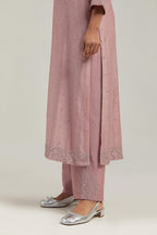 Pink silk Chanderi straight kurta set with hand-embroidered mirror at the neck, hem and sleeves, highlighted with scattered silver sequin and mirror embellishments all-over.