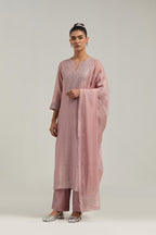 Pink silk Chanderi straight kurta set with hand-embroidered mirror at the neck, hem and sleeves, highlighted with scattered silver sequin and mirror embellishments all-over.