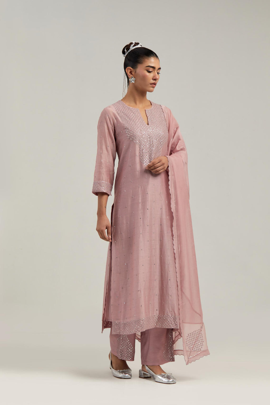 Pink silk Chanderi straight kurta set with hand-embroidered mirror at the neck, hem and sleeves, highlighted with scattered silver sequin and mirror embellishments all-over.