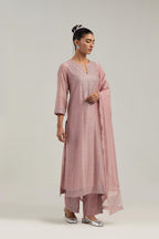Pink silk Chanderi straight kurta set with hand-embroidered mirror at the neck, hem and sleeves, highlighted with scattered silver sequin and mirror embellishments all-over.