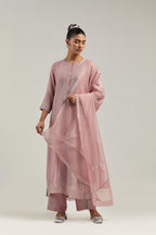 Pink silk Chanderi straight kurta set with hand-embroidered mirror at the neck, borders running along the hem and sleeve edges, and scattered silver sequin and mirror embellishments all-over.