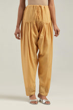 Yellow silk Chanderi salwar with hand-embroidered mirror & sequins work in a broad border at the hem.