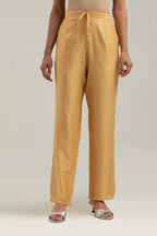 Yellow silk Chanderi pants with hand-embroidered paisley motifs with delicate mirror and sequins work at the hem.