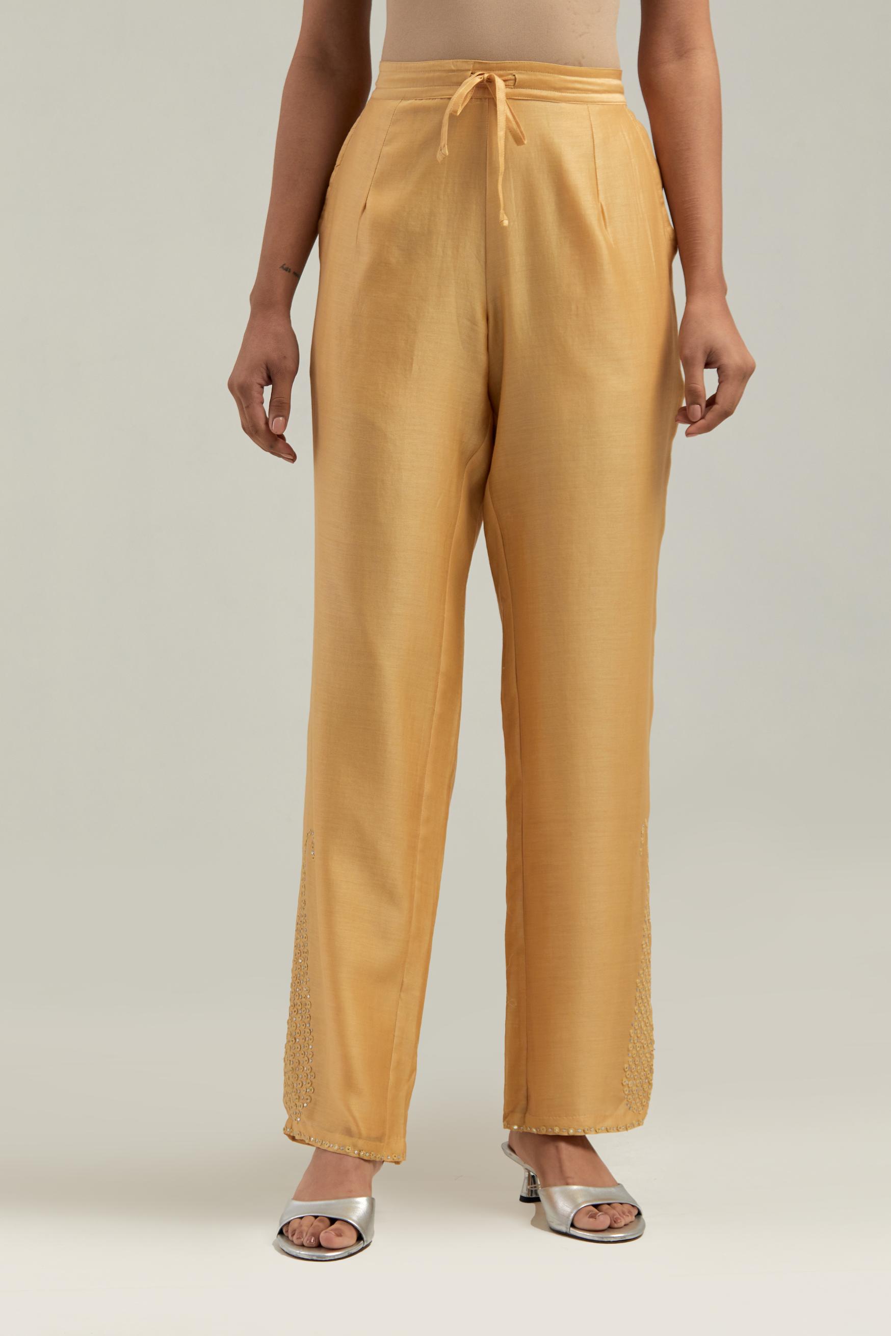 Yellow silk Chanderi pants with hand-embroidered paisley motifs with delicate mirror and sequins work at the hem.