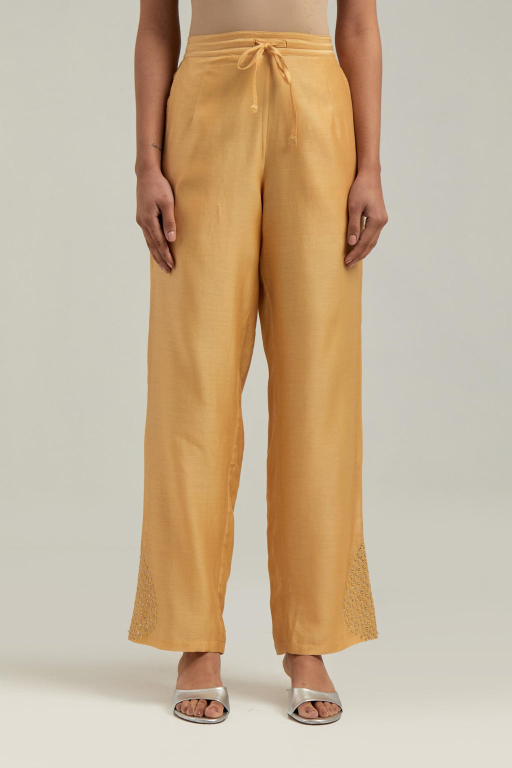 Yellow Silk Chanderi pants with hand embroidered leaf motifs with delicate mirror & sequins work at hem.