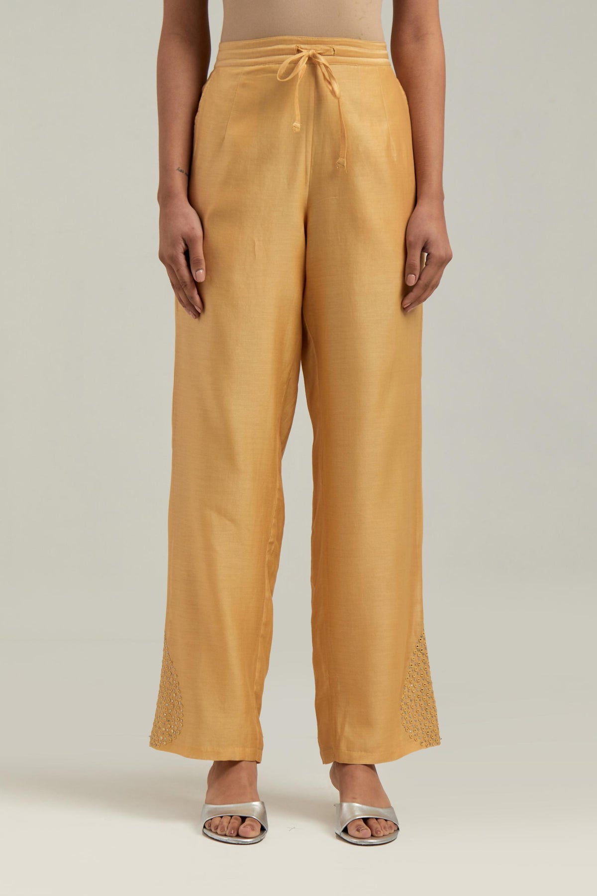 Yellow Silk Chanderi pants with hand embroidered leaf motifs with delicate mirror & sequins work at hem.