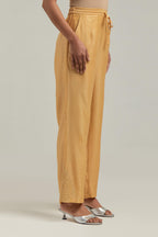 Yellow Silk Chanderi pants with hand embroidered leaf motifs with delicate mirror & sequins work at hem.