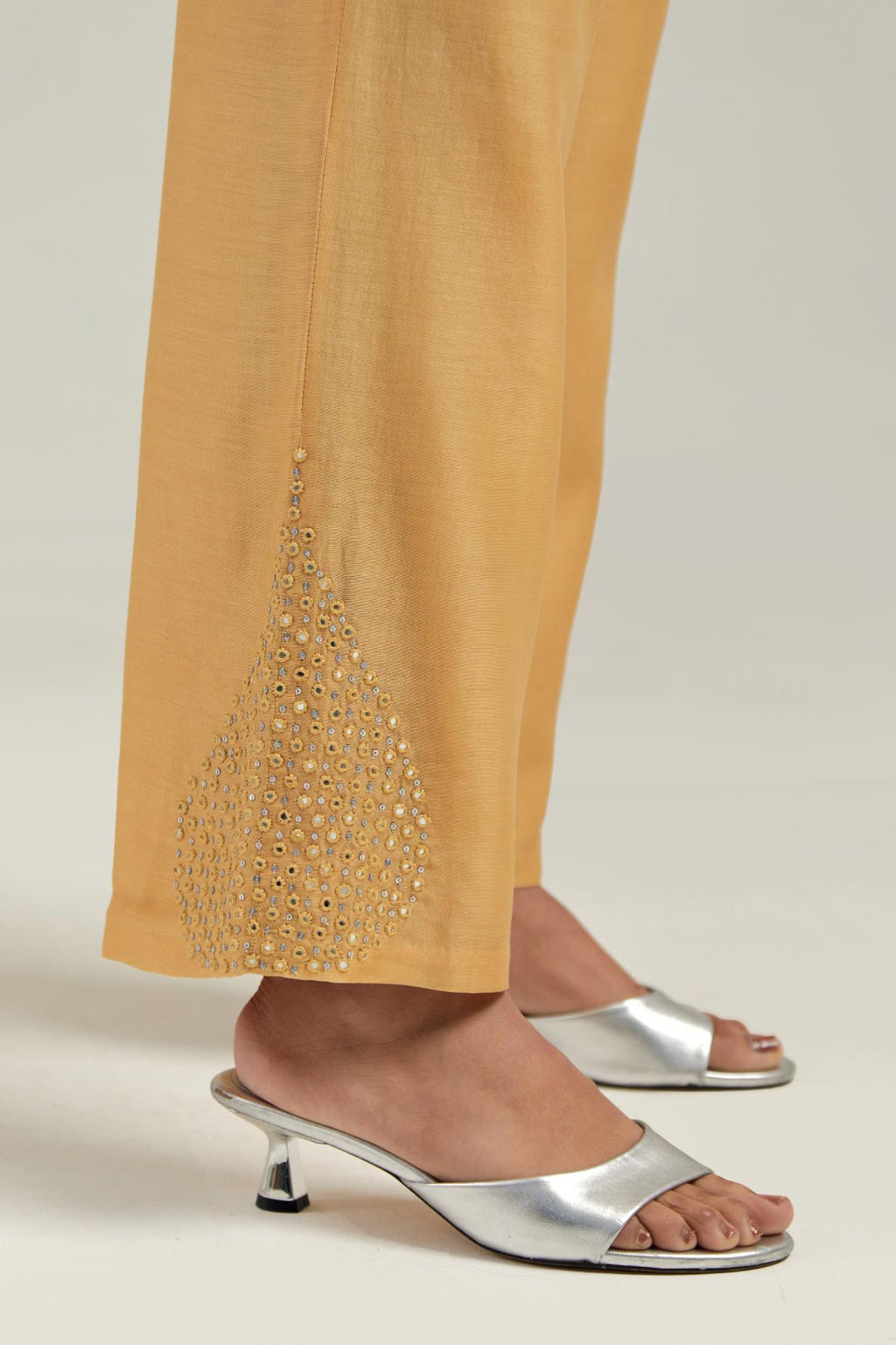Yellow Silk Chanderi pants with hand embroidered leaf motifs with delicate mirror & sequins work at hem.