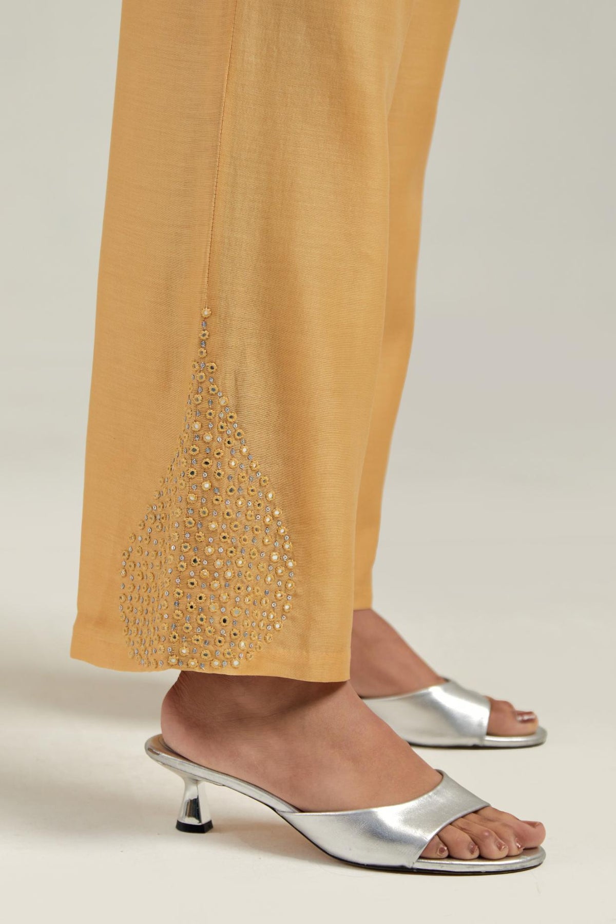 Yellow Silk Chanderi pants with hand embroidered leaf motifs with delicate mirror & sequins work at hem.