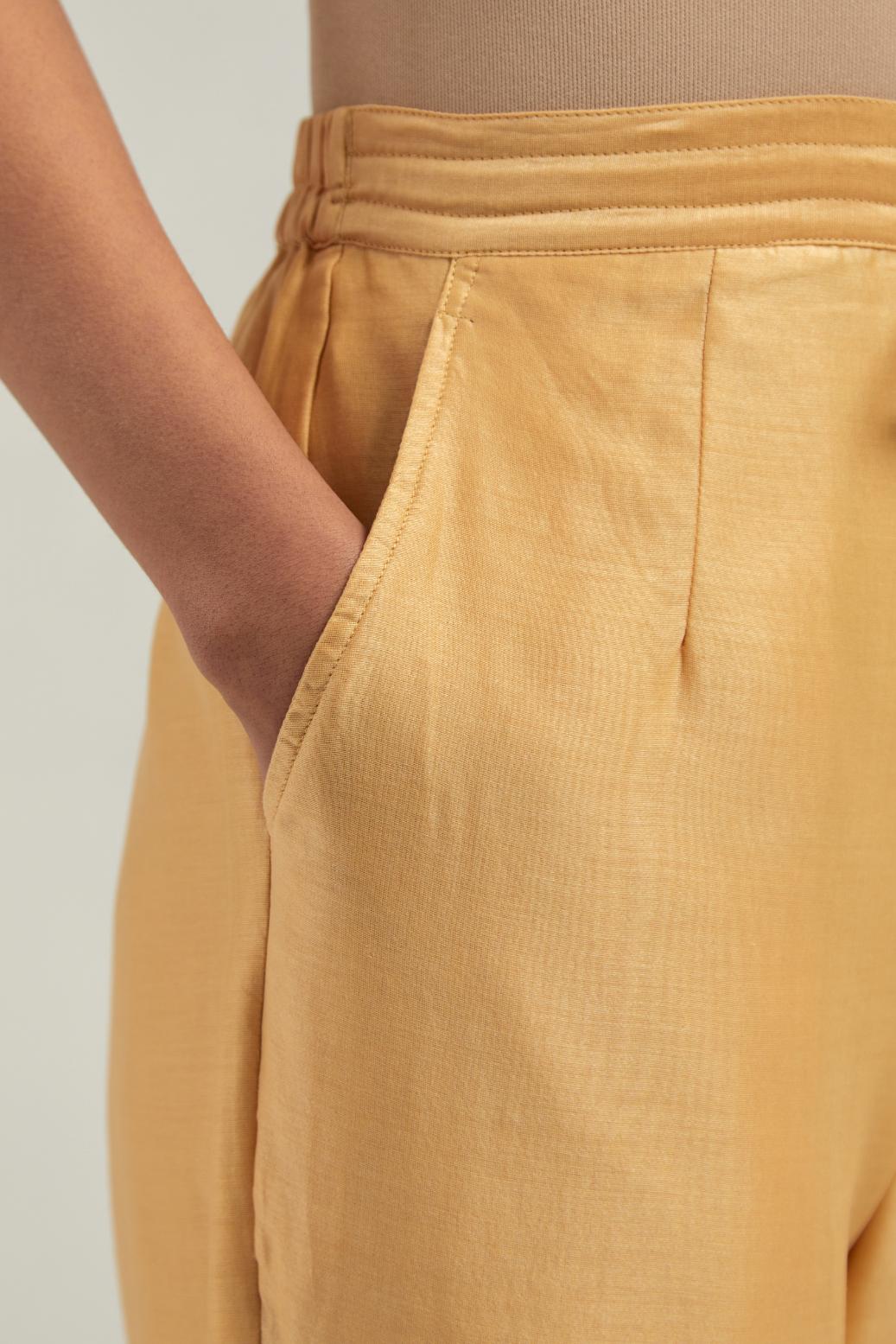 Yellow Silk Chanderi pants with hand embroidered leaf motifs with delicate mirror & sequins work at hem.