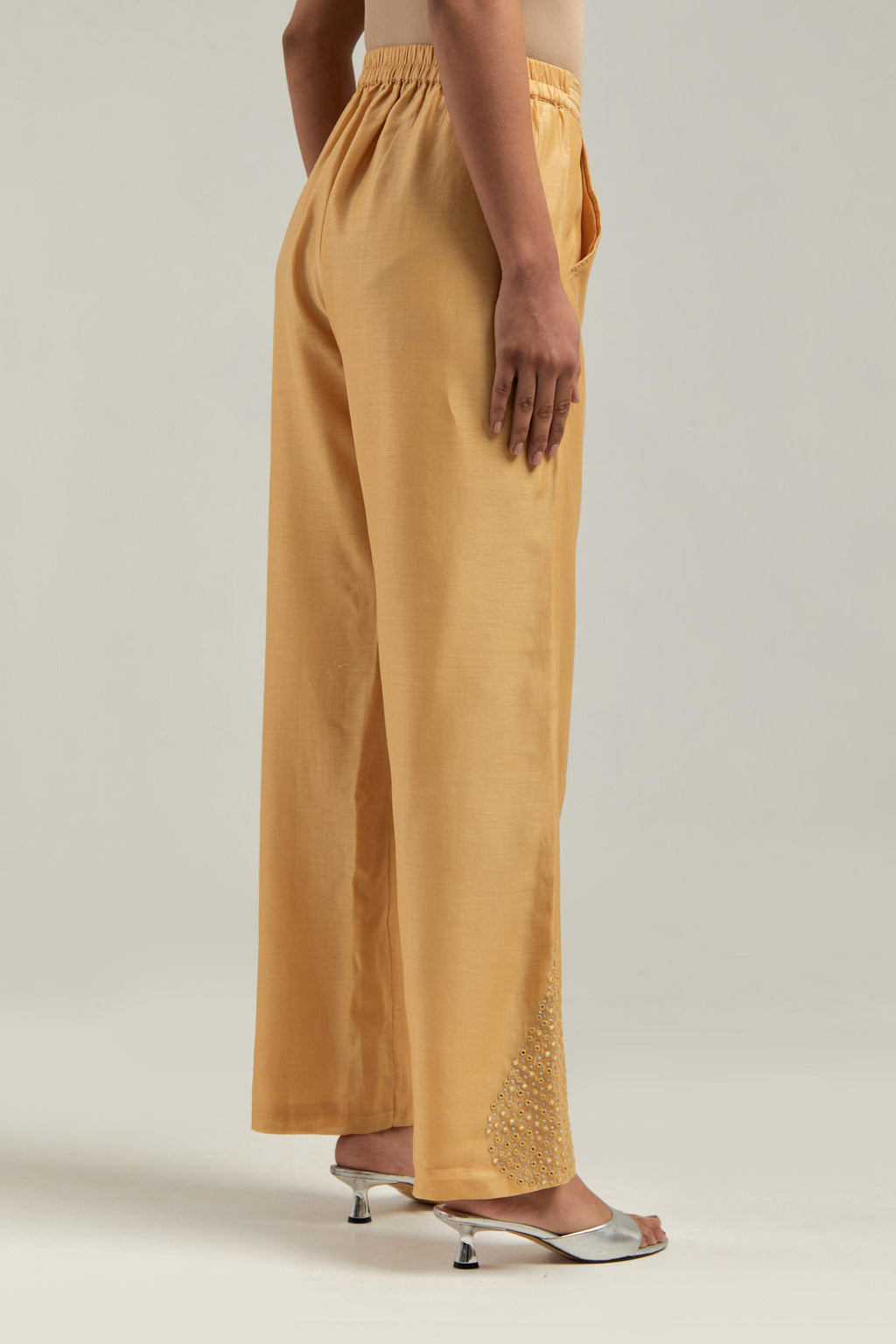 Yellow Silk Chanderi pants with hand embroidered leaf motifs with delicate mirror & sequins work at hem.