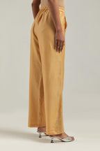 Yellow Silk Chanderi pants with hand embroidered leaf motifs with delicate mirror & sequins work at hem.