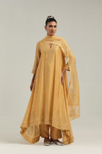 Yellow silk Chanderi kurta set with asymmetric hem and hand-embroidered leaf motifs with delicate mirror and sequins work at the neck, sleeves, and hem, with a mirror border running along the edges.