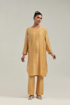 Yellow Silk Chanderi short kurta set with hand-embroidered paisley motifs with delicate mirror and sequins work all-over the kurta.