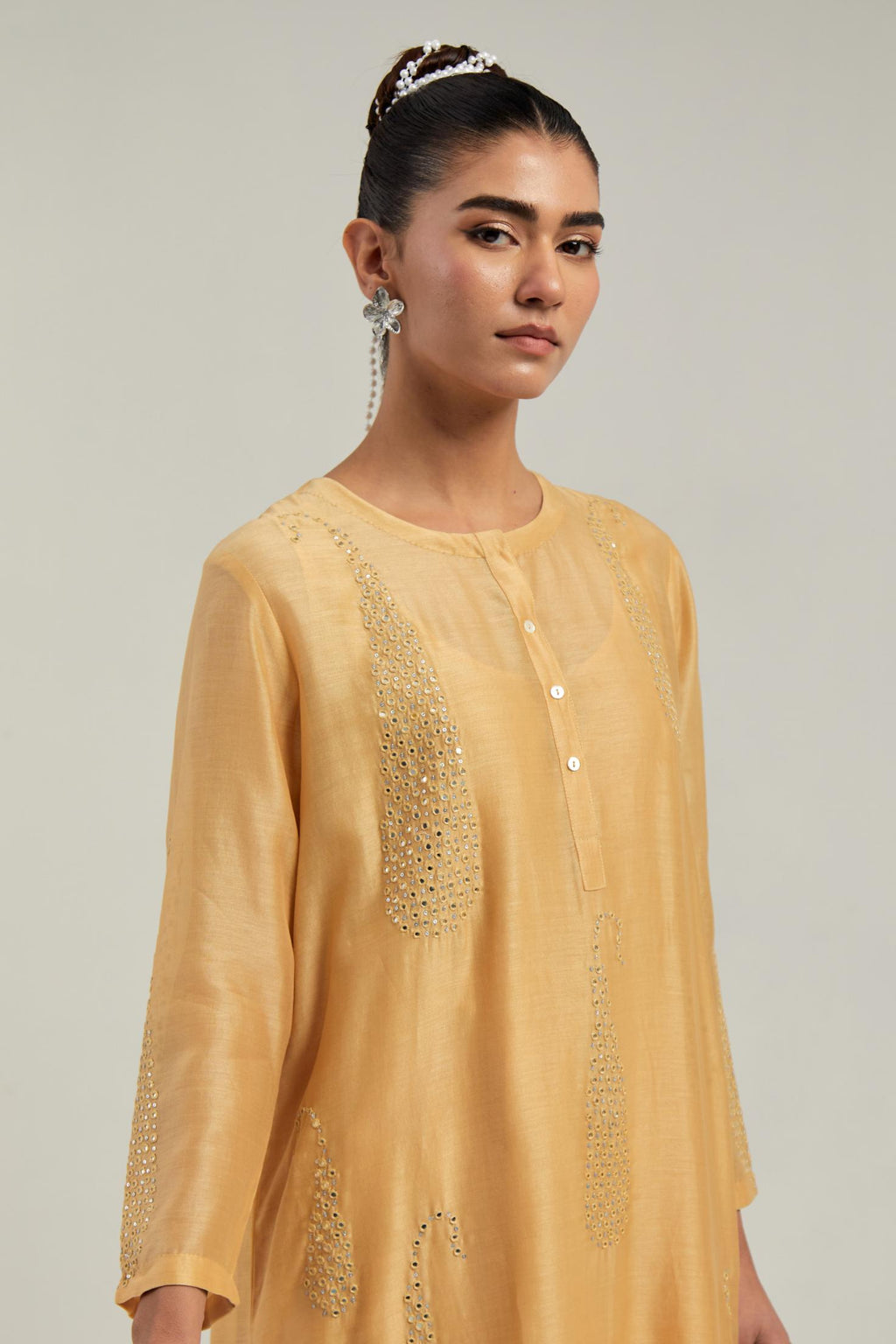 Yellow Silk Chanderi short kurta set with hand-embroidered paisley motifs with delicate mirror and sequins work all-over the kurta.