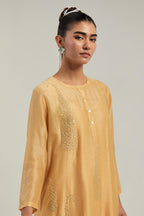 Yellow Silk Chanderi short kurta set with hand-embroidered paisley motifs with delicate mirror and sequins work all-over the kurta.