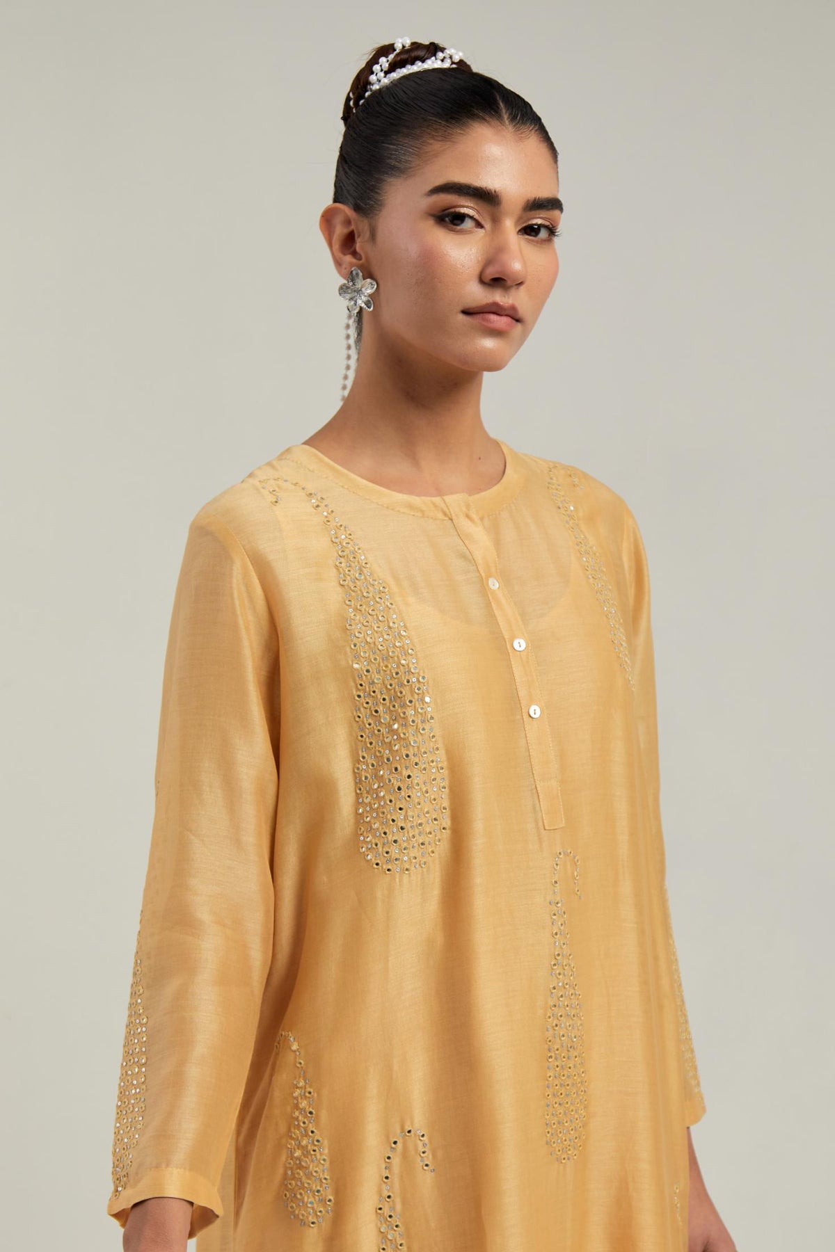 Yellow Silk Chanderi short kurta set with hand-embroidered paisley motifs with delicate mirror and sequins work all-over the kurta.