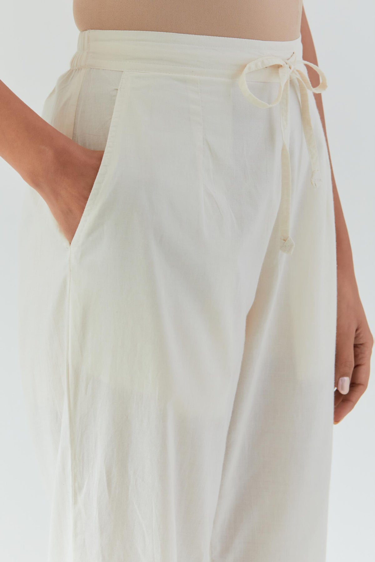 Off white cotton straight pants detailed with yellow & green colored applique, highlighted with bead & sequins work.