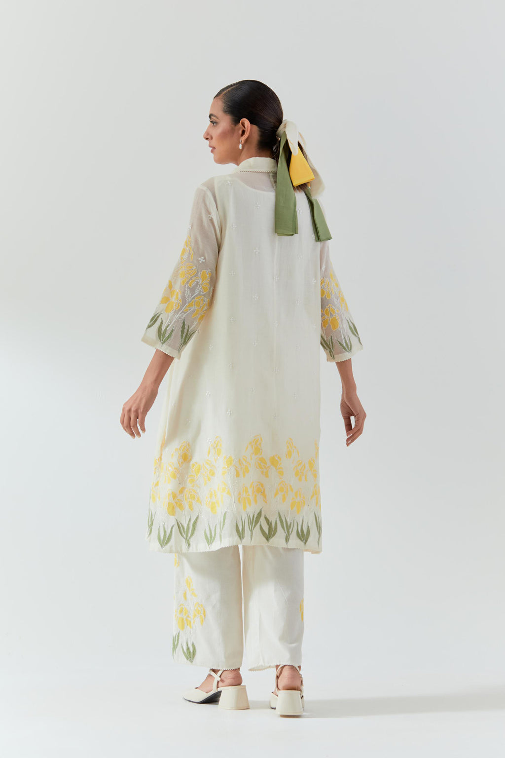 Off white cotton chanderi A-line short kurta set with yellow & green applique work at hem, highlighted with bead & sequins work.