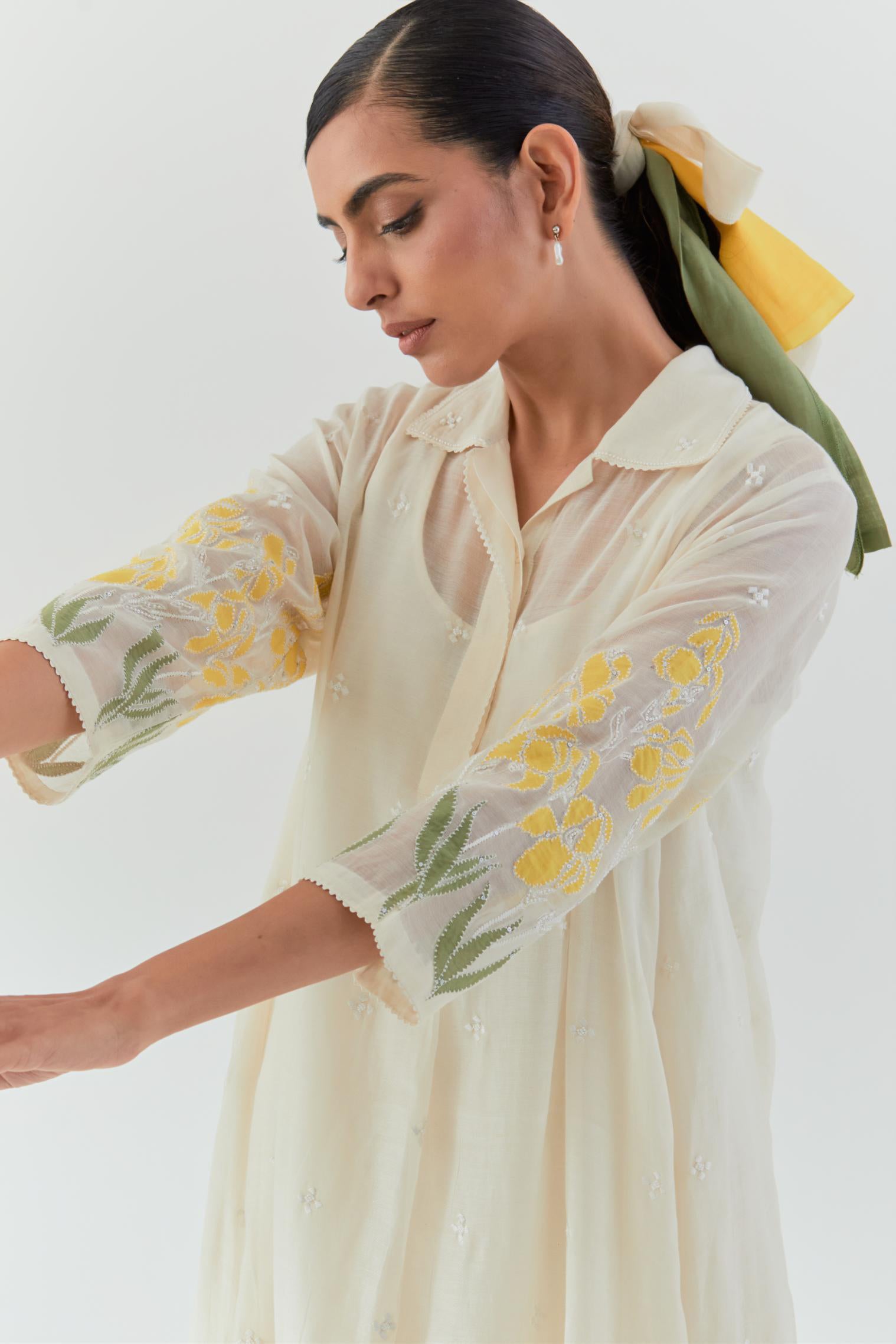 Off white cotton chanderi A-line short kurta set with yellow & green applique work at hem, highlighted with bead & sequins work.