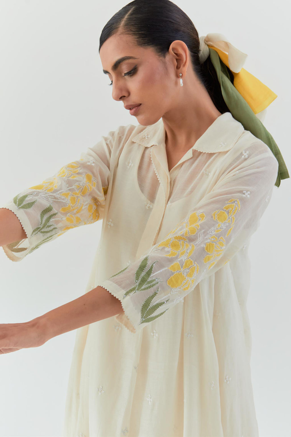 Off white cotton chanderi A-line short kurta set with yellow & green applique work at hem, highlighted with bead & sequins work.
